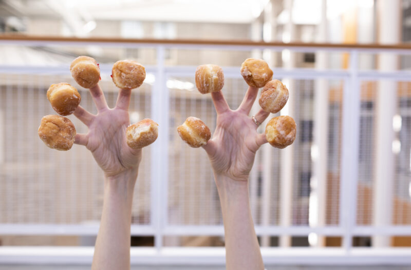 Donuts in hand Free Stock Photo